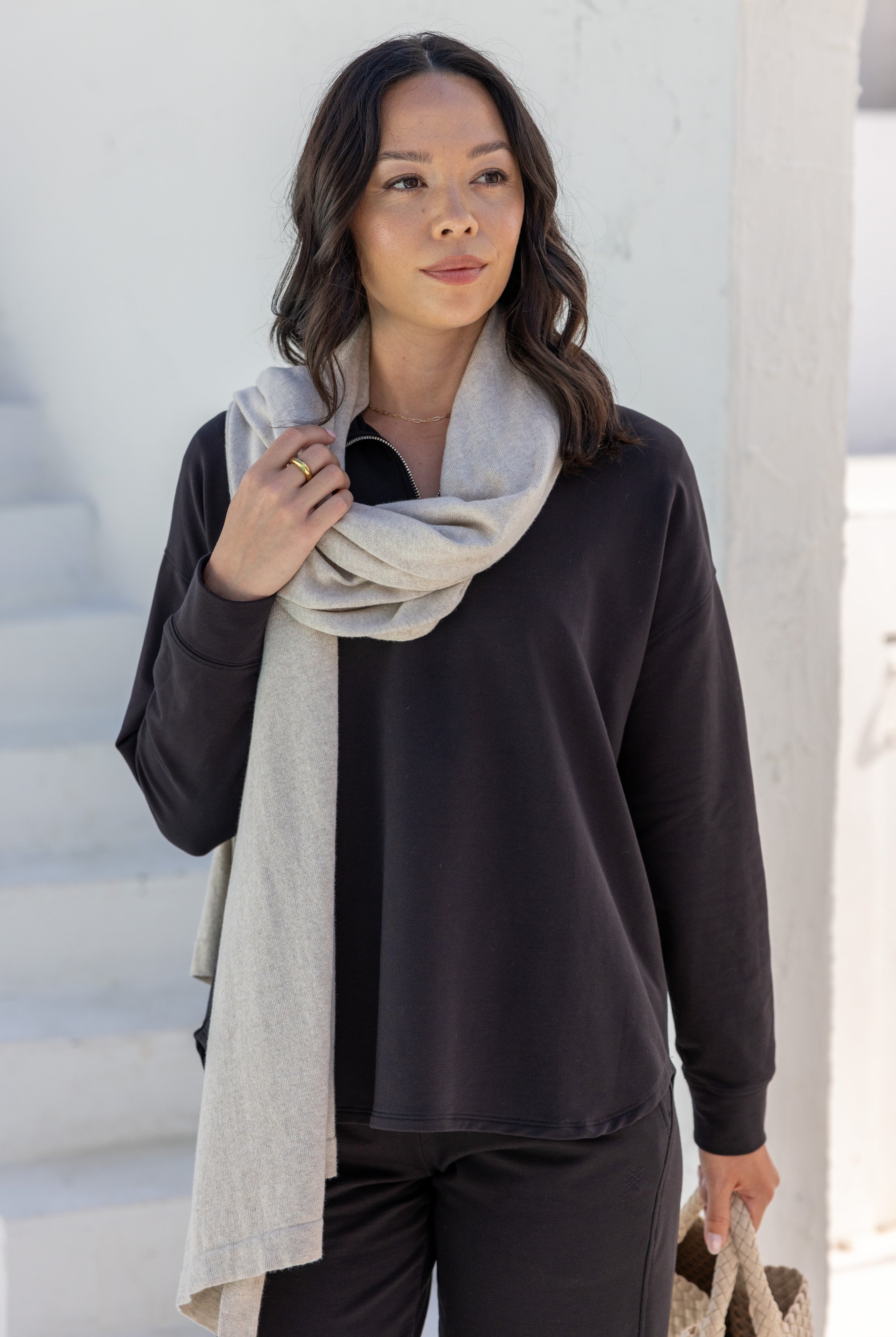 Woman wearing a Beige Scarf wrapped around her neck